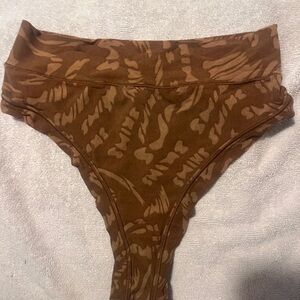 Skims mesh thong panties. 
Latte swirl pattern.